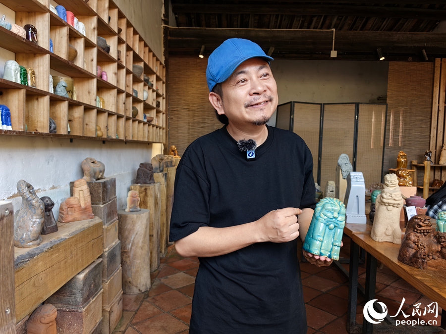陶藝師陳青山介紹自己創(chuàng)作的“風獅爺”文創(chuàng)產品。人民網 蘇海森攝